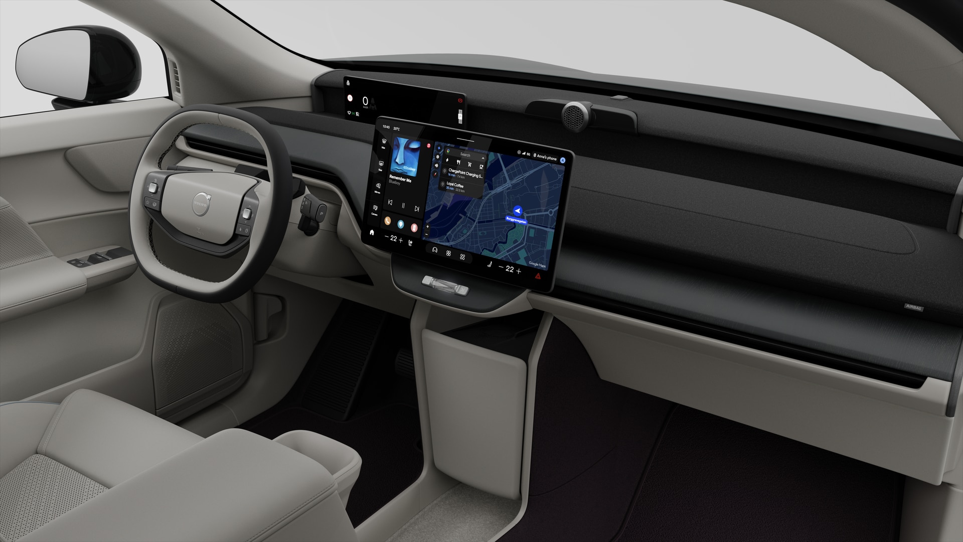 Vue intérieure d’une Volvo montrant le tableau de bord, le volant, la console centrale et l’écran d’affichage numérique sur un fond de studio uni.