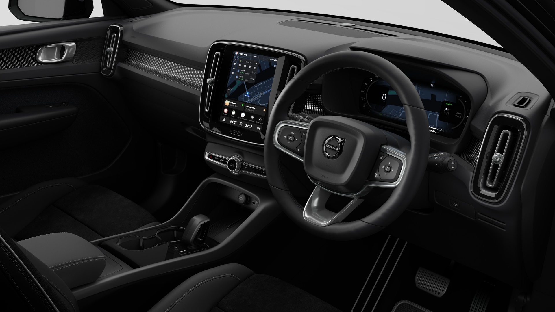 Interior view of a Volvo car showing the dashboard, steering wheel, center console, and digital display screen in a plain studio background.