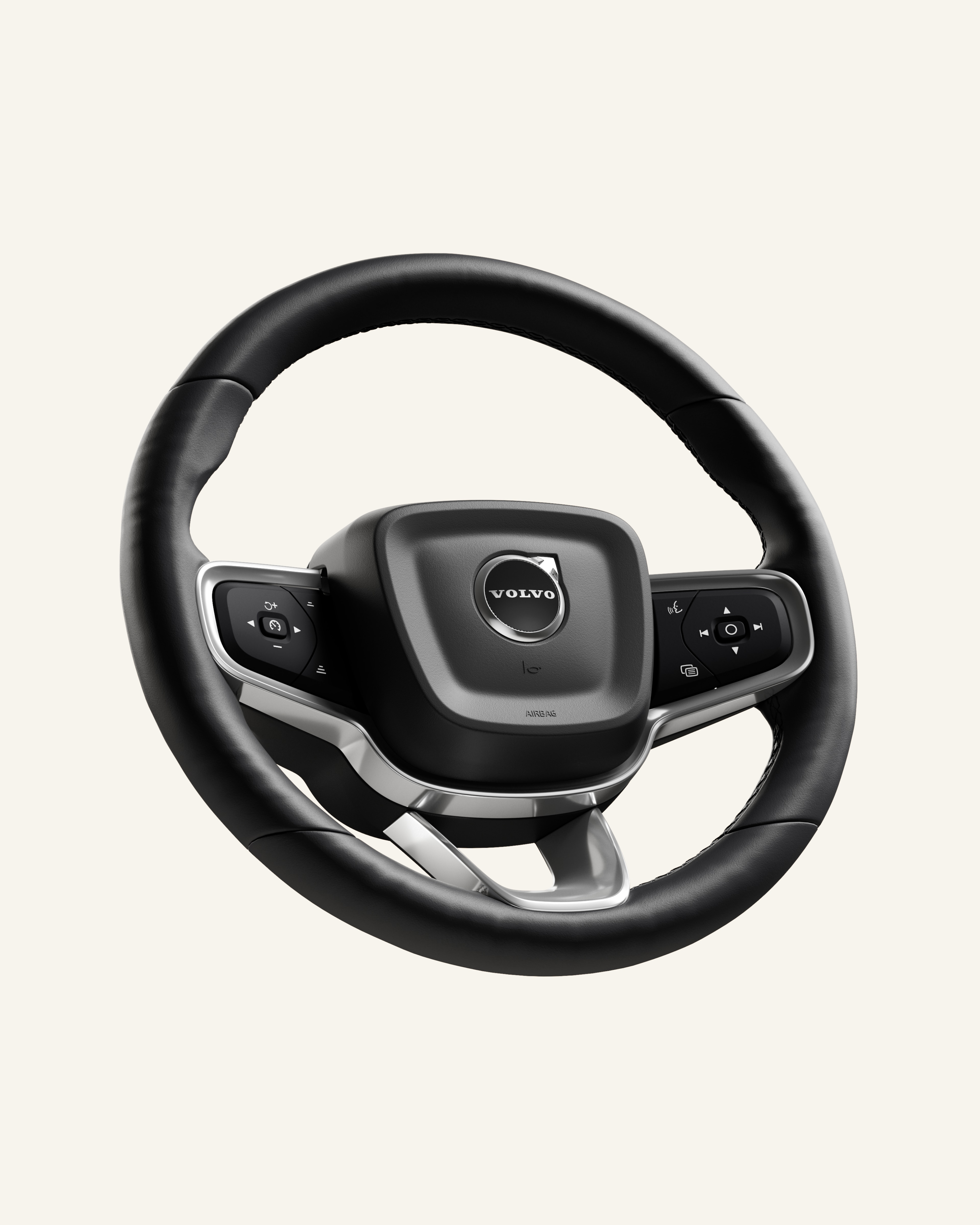 Binnenaanzicht van het stuur van een Volvo auto getoond vanuit een driekwart aanzicht tegen een effen studioachtergrond.